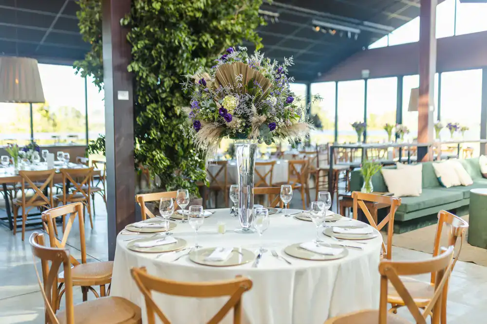 Wedding dining setup inside a lush botanical glasshouse