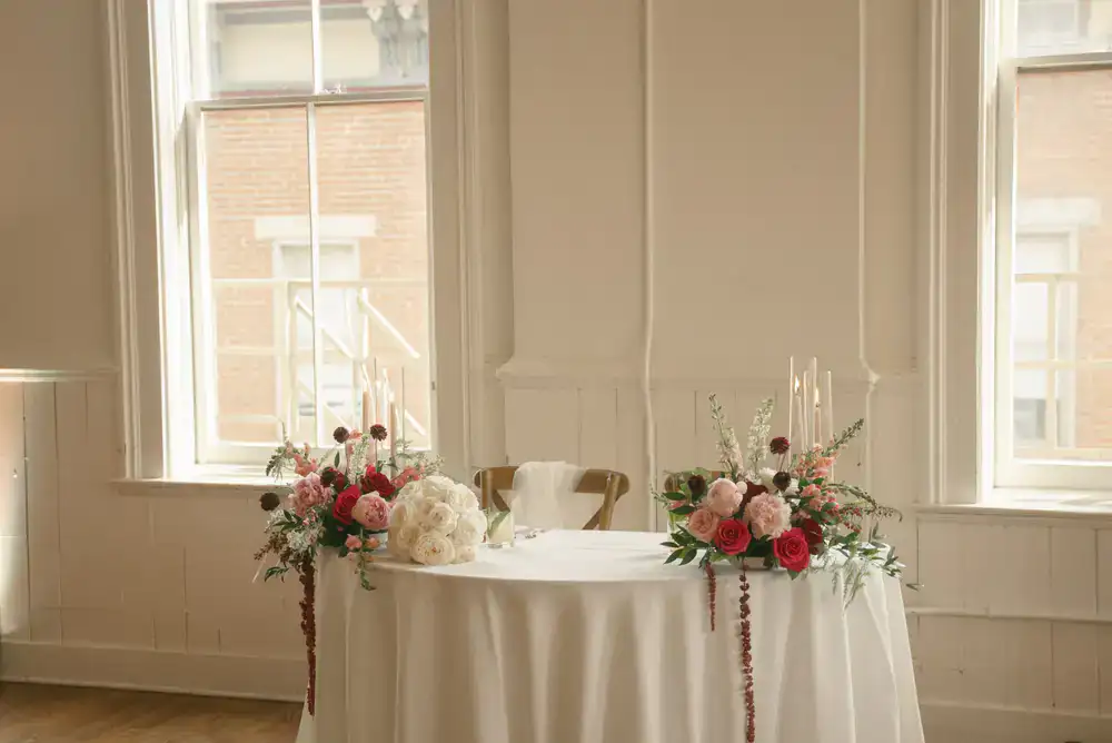 Classic white floral centerpieces in a historic venue