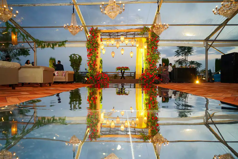 Glamorous waterfront reception with outdoor chandeliers