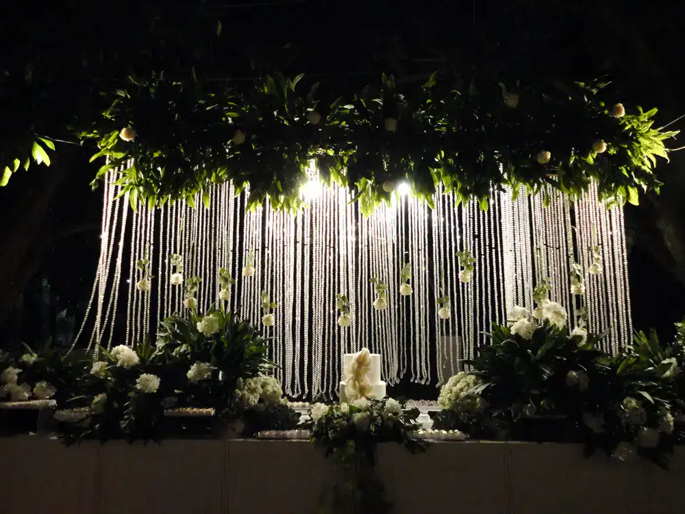 Elegant outdoor wedding reception with draped floral arrangements