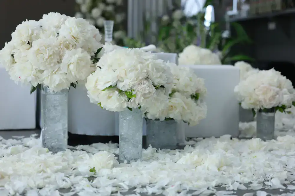 Close-up of a floral designer arranging exquisite blooms for a wedding reception
